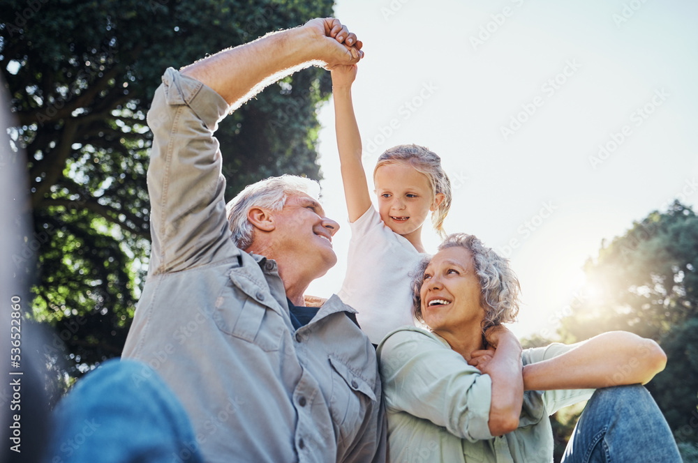 Grandparents playing together with a girl in the park in the morning. Family, love and grandchild bo