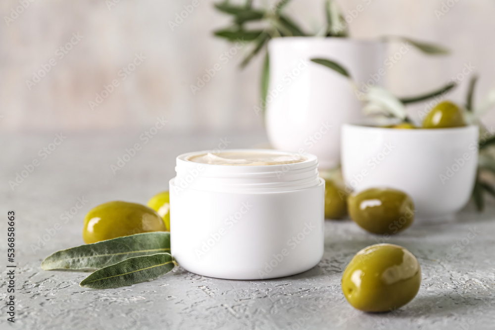 Jar of natural olive cream on table