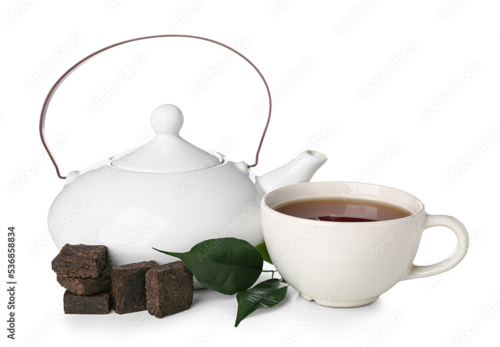 Dry pressed puer tea with leaves, cup and teapot on white background