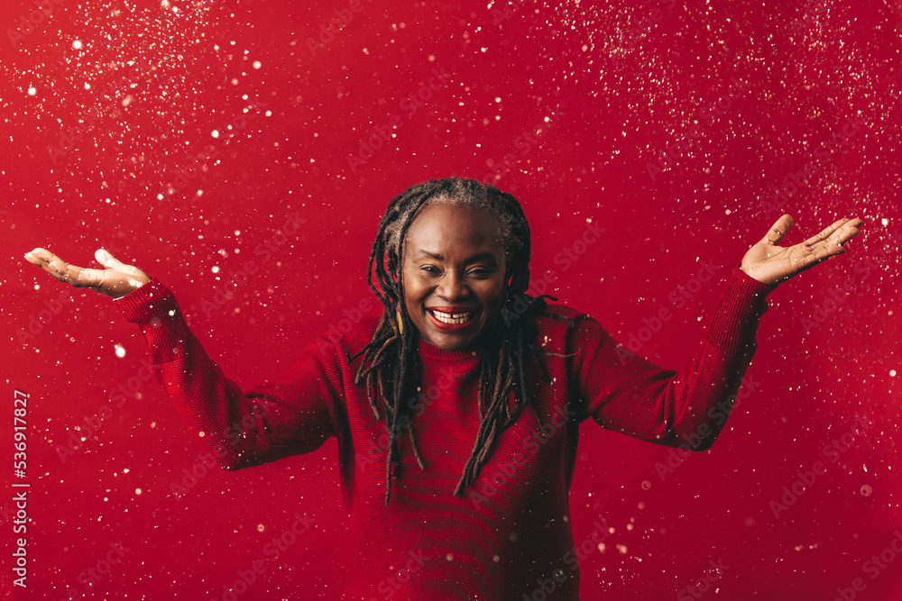 Excited mature woman celebrating with confetti