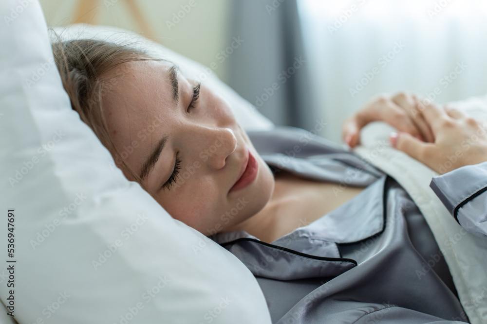 Beautiful Caucasian woman sleeping with happiness in bedroom at home. 