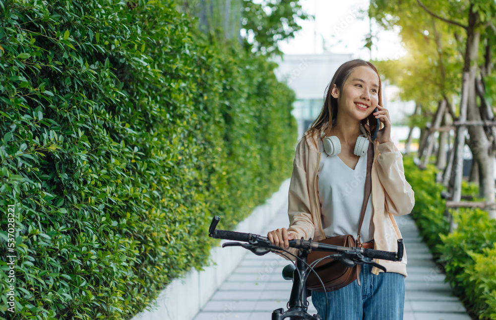 Beautiful Asian woman listening favourite music on headphones from mobile phone, Happiness relaxatio