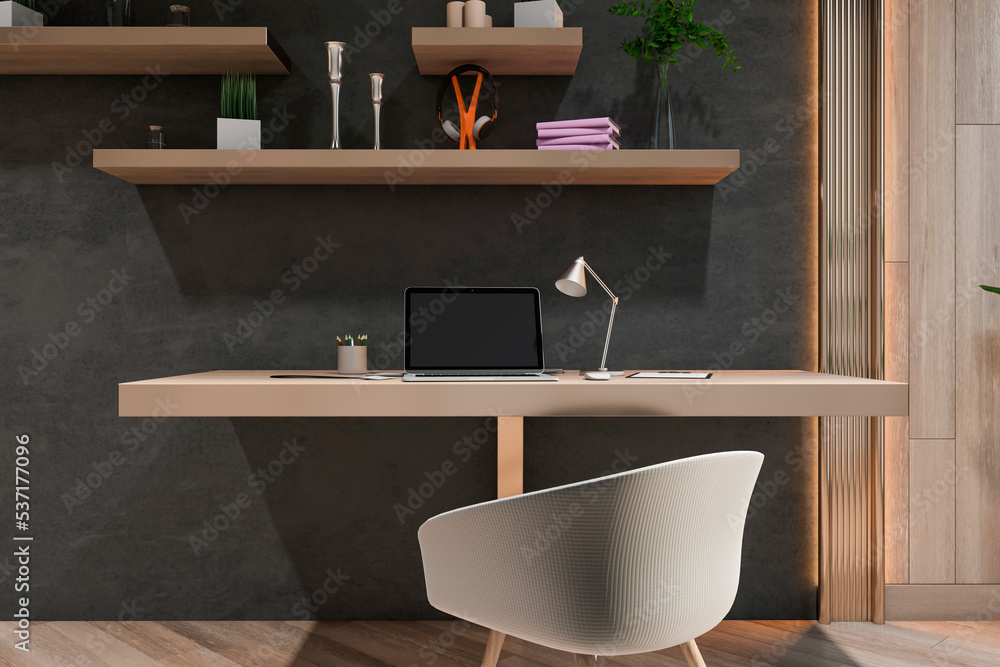 Front view on stylish workspace with modern laptop on wooden surface, grey chair and dark wall backg