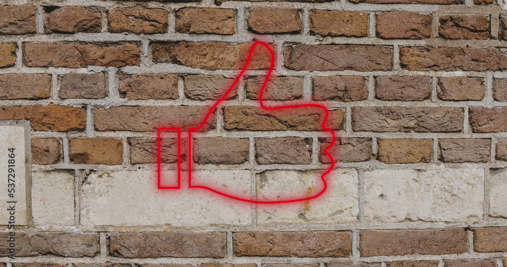 Composite of digital red like button icon against brick wall, copy space