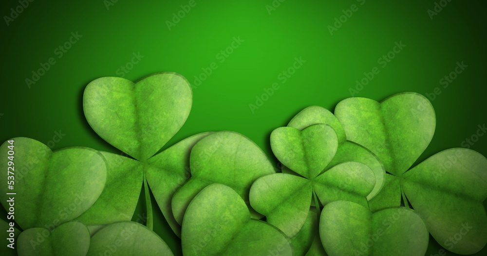 Image of clovers on green background with copy space