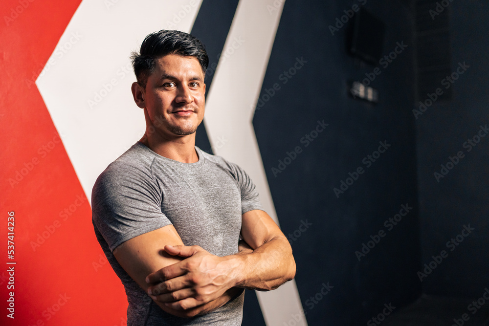 Portrait of Caucasian sportsman exercise in fitness gym look at camera. 