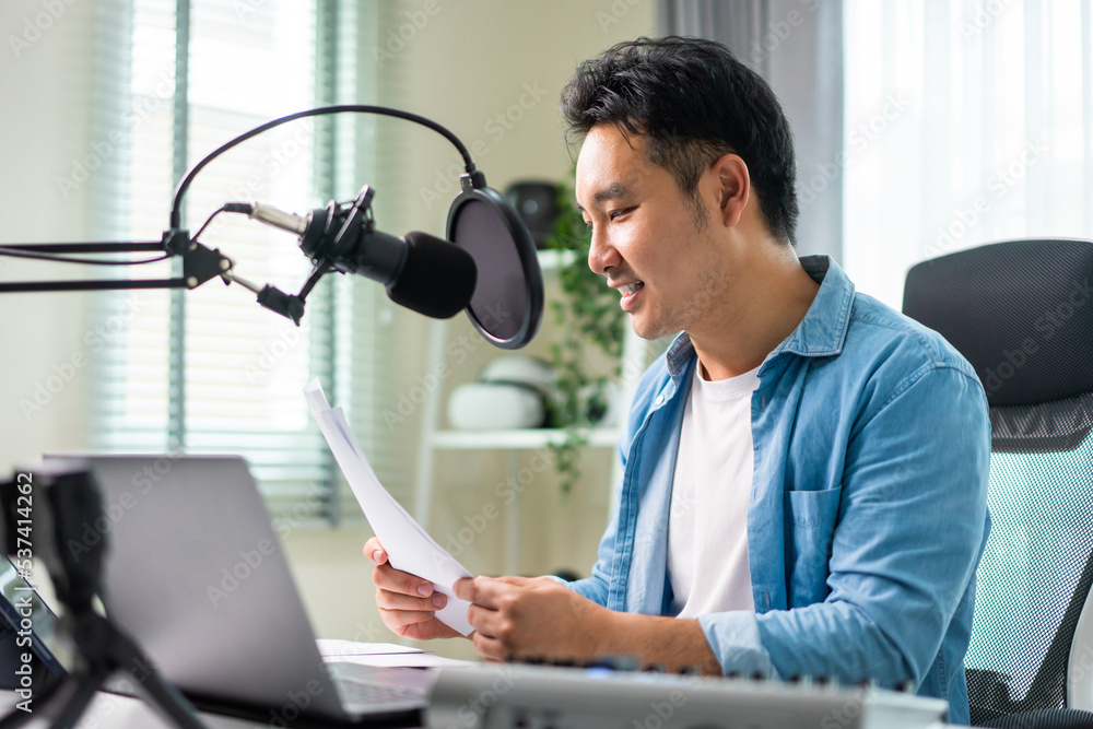 Asian attractive audio DJ man speaking into microphone to broadcasting. 