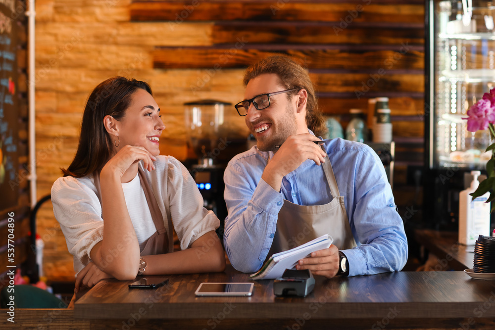 Business owners working at table in their cafe