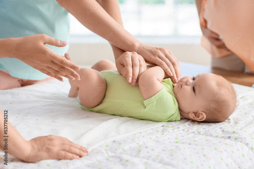 Female speaker teaching expectant mothers how to swaddle baby at course, closeup