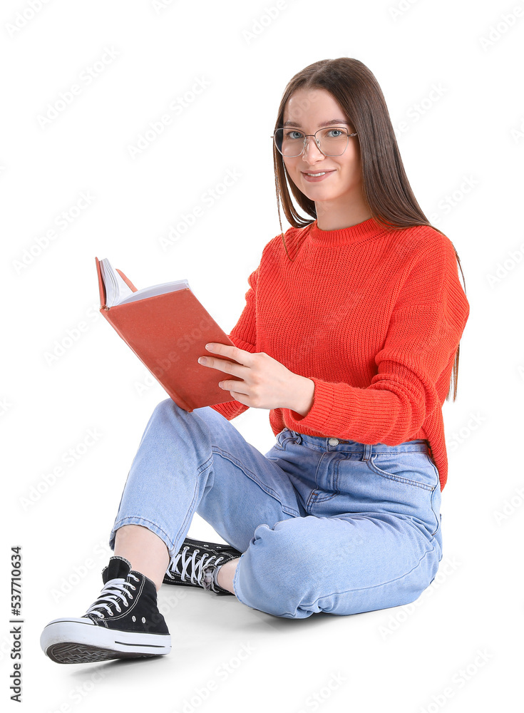 Young woman in eyeglasses reading book on white background