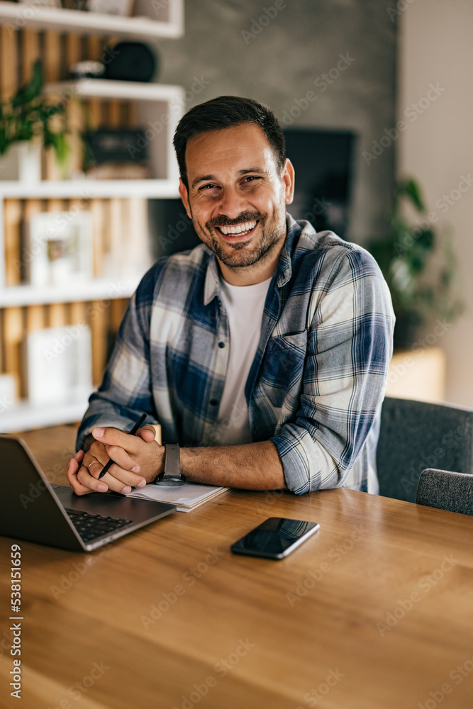 Portrait of a businessman, smiling for the camera while working