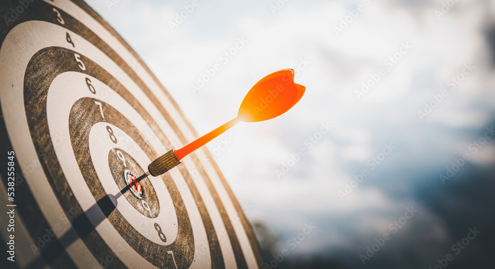 Close up shot red darts arrows in the target  of dartboard cente