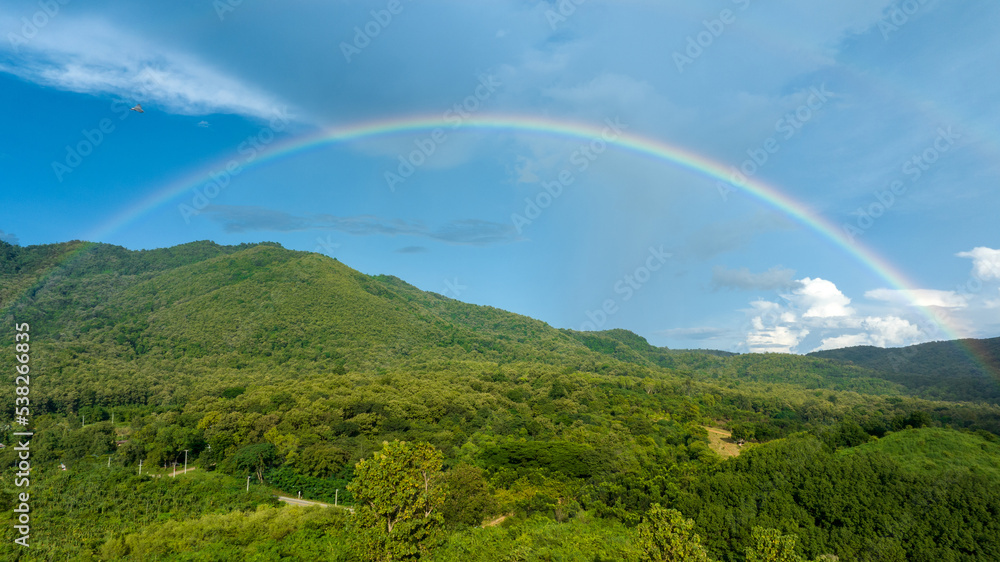 Rainbow on Sky in the mountains, Panorama of flying in a Nature rainbow in the rain, aerial view of 