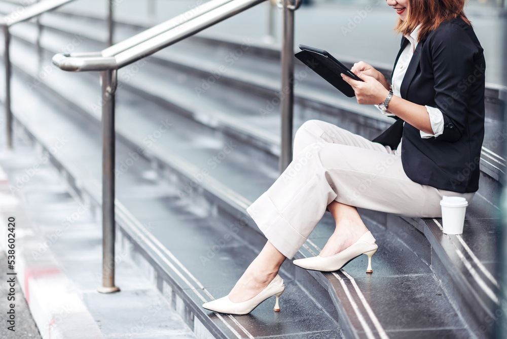 Young Asian businesswoman using tablet and walking in airport before business trip. Beautiful woman 