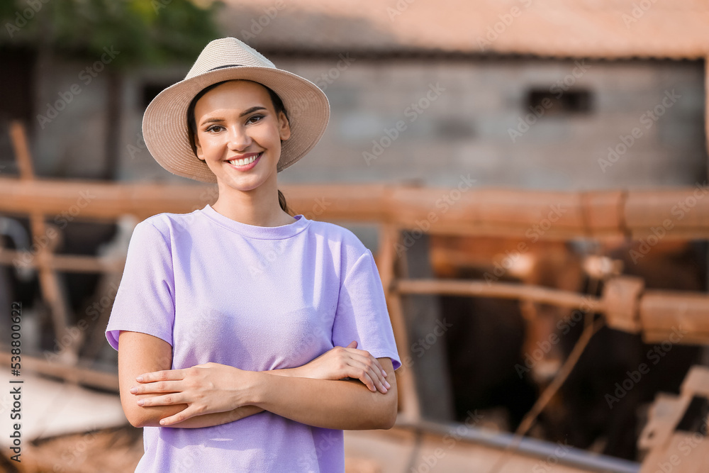 Young female worker near paddock on farm