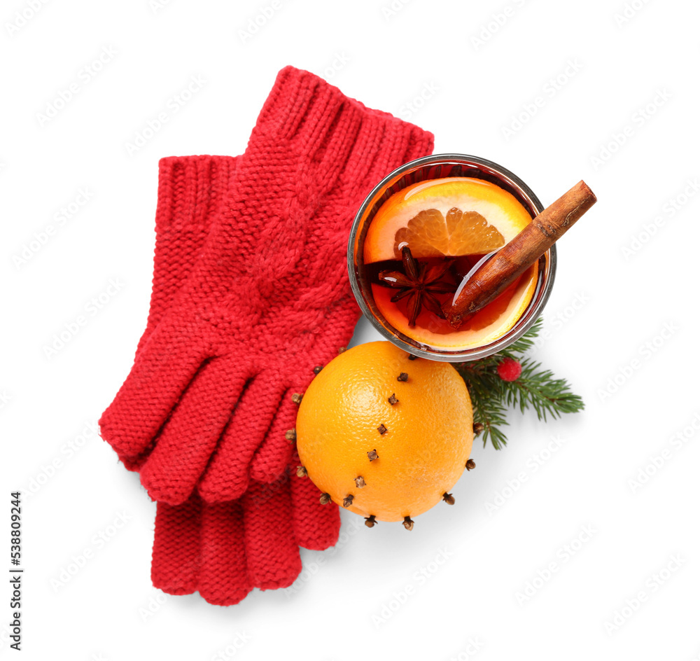 Glass of mulled wine, orange and warm gloves on white background