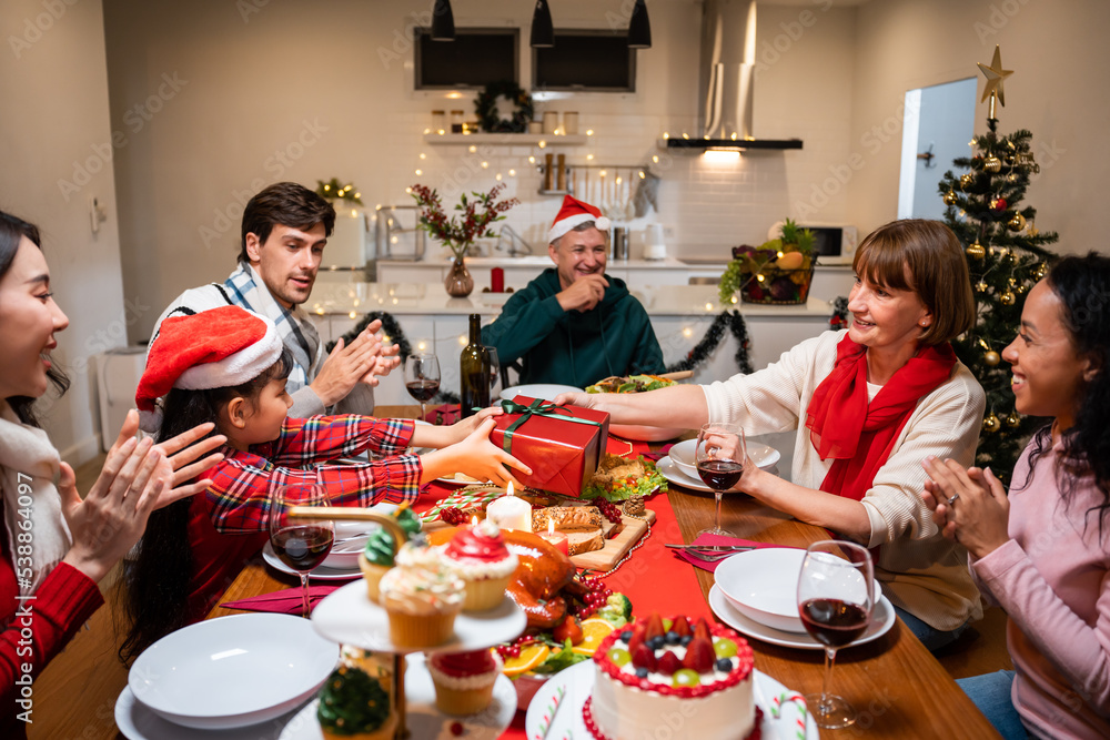 Multi-ethnic family exchanging presents during Christmas party at home