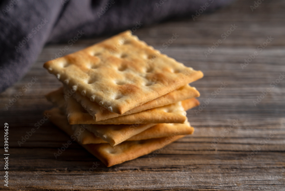 Cracker placed against old wooden background.