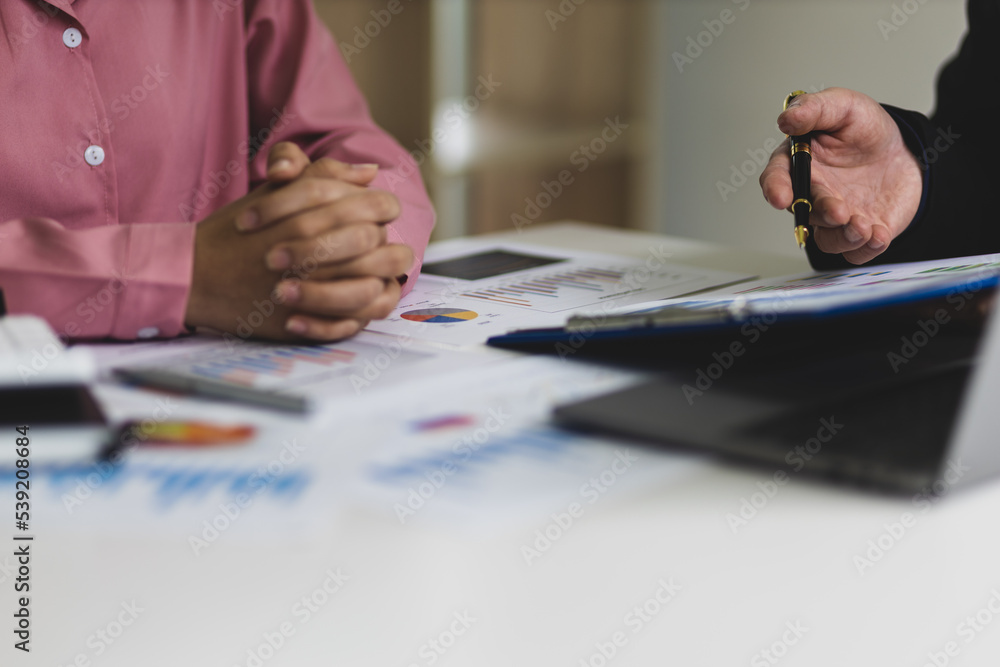 Businessmen meeting to discuss company sales report charts and analyze market strategies. Financial 