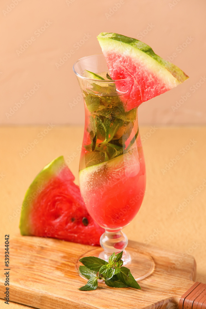 Board with glass of cold watermelon fresh on color background, closeup