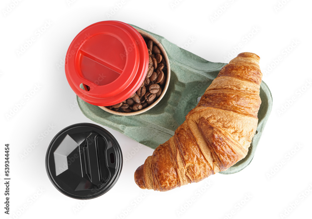 Paper cups with coffee beans and croissant on white background