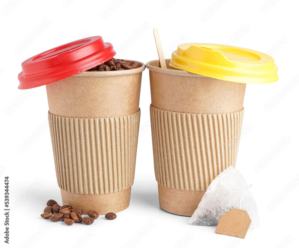 Paper cups, coffee beans and tea bag on white background