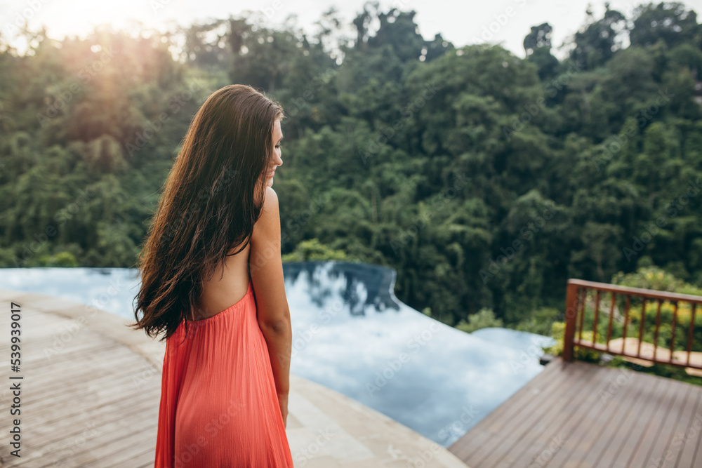 Beautiful woman standing near swimming pool