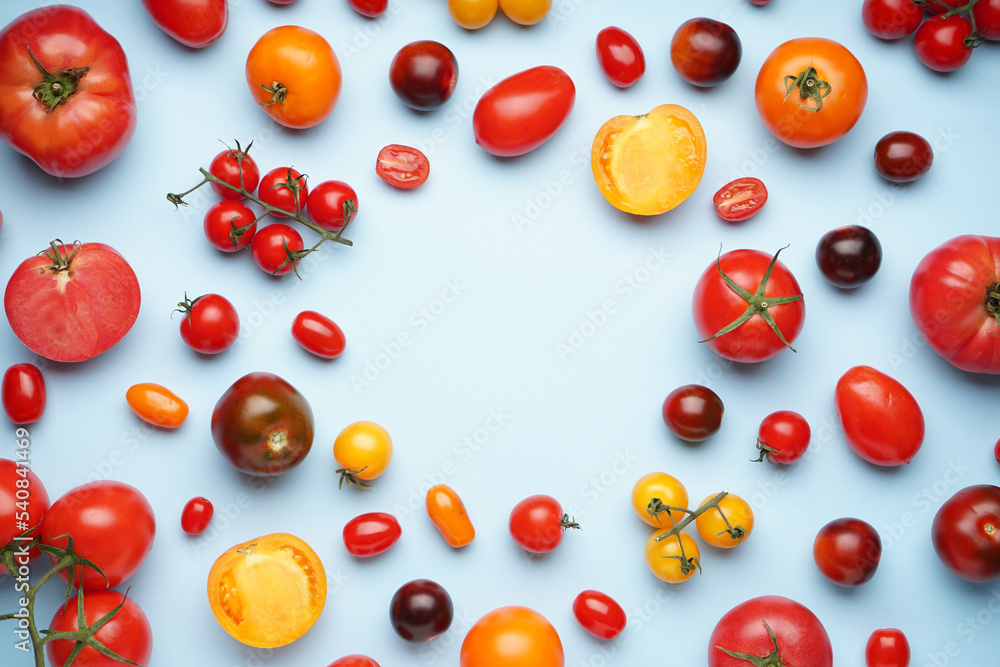 Frame made of different ripe tomatoes on color background