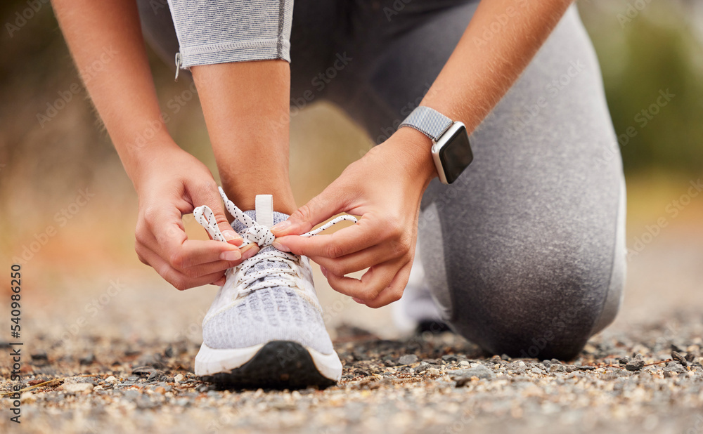 Shoes, fitness and exercise with a sports woman tying her laces before training, running or a workou