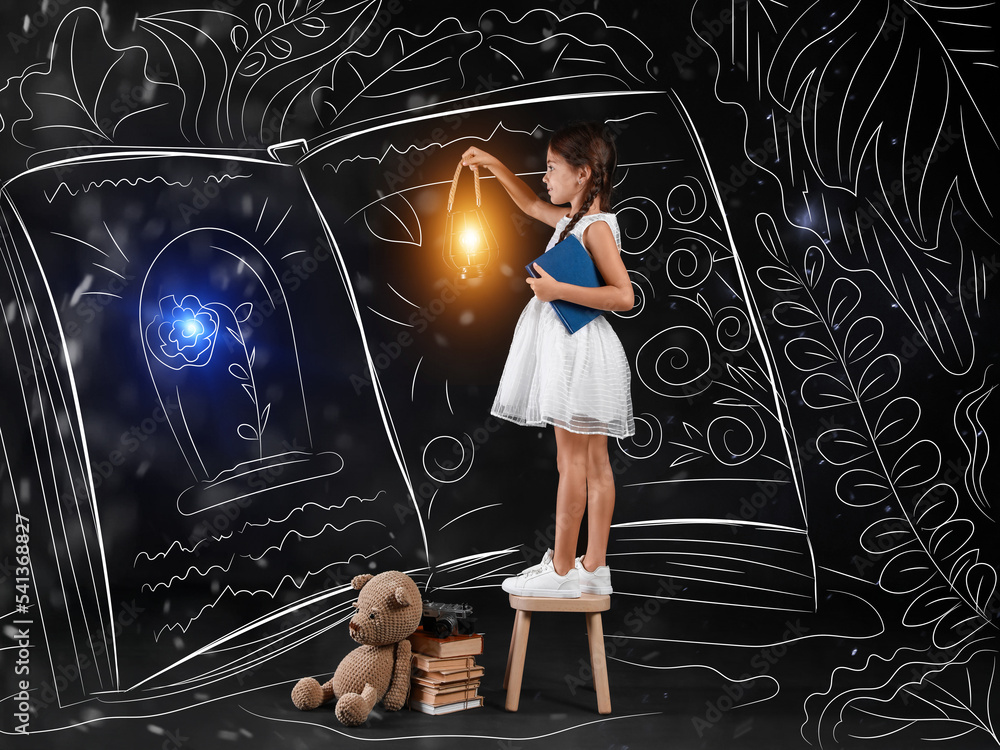 Cute little girl with lantern near drawn big magic book on dark background