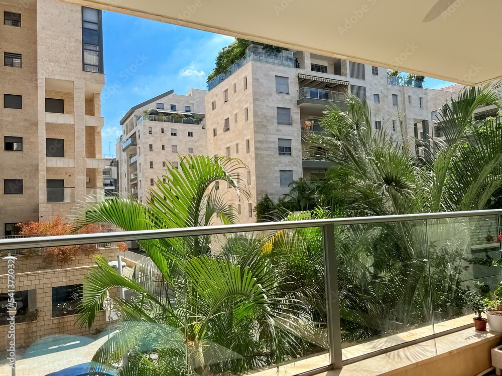 City view from modern balcony on sunny day