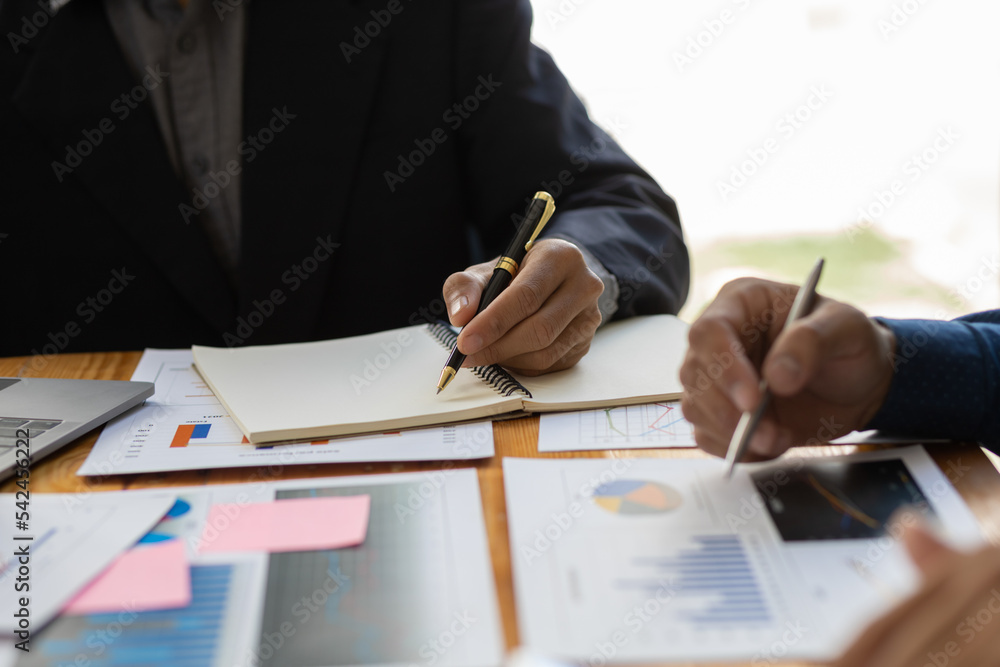 Businessman meeting and working with financial report for analysis data figures to plan business str