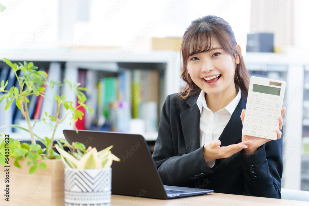 オフィスで電卓を持つ女性