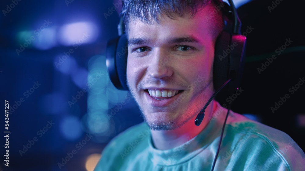 Portrait of a Gamer Playing Online Video Game on Computer. Close Up of Stylish Male in Headphones En