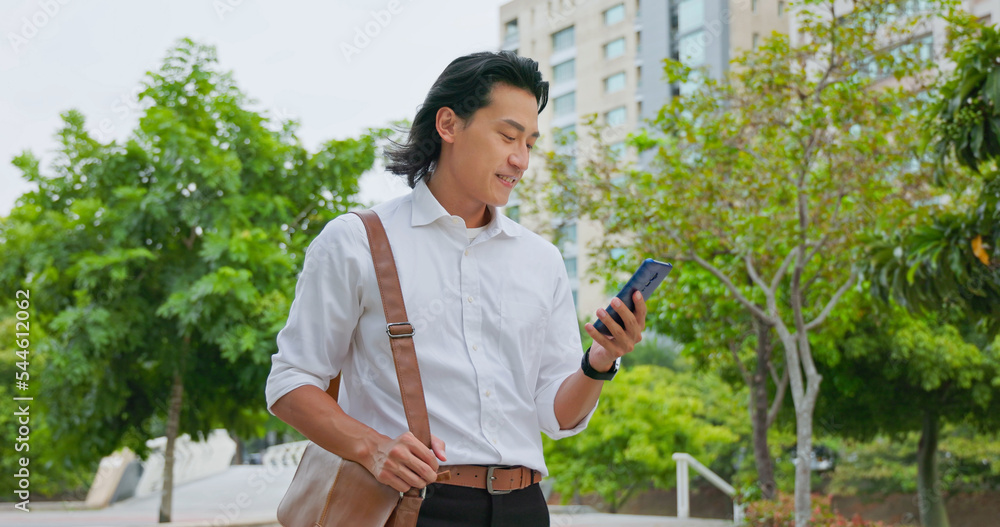 man using phone commuting