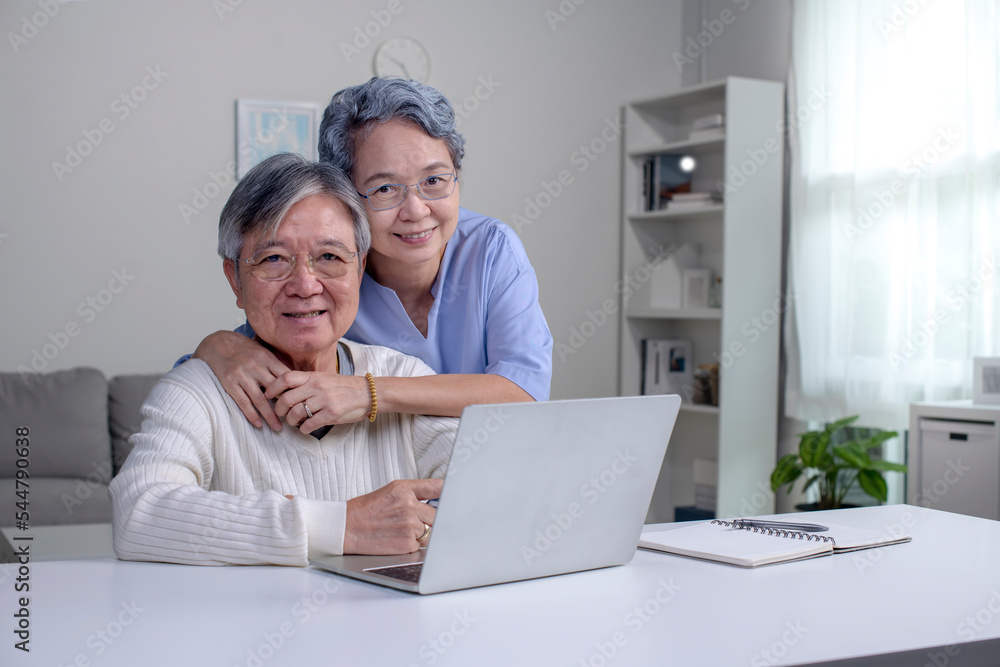 Happy Asian Senior couple at home. Handsome old man and attractive old woman are spending time toget