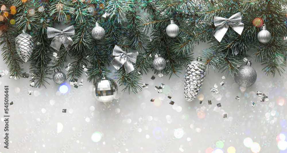 Fir branches with Christmas decorations on light background, top view