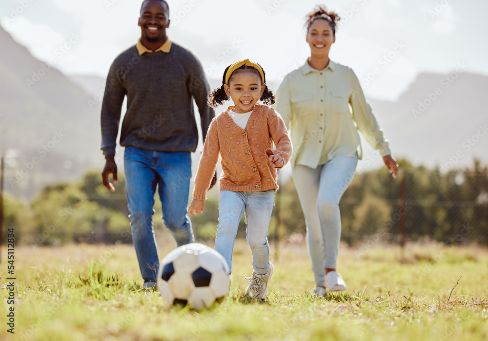 Happy family, soccer ball and playing on the grass in nature for fun, bonding and active exercise in