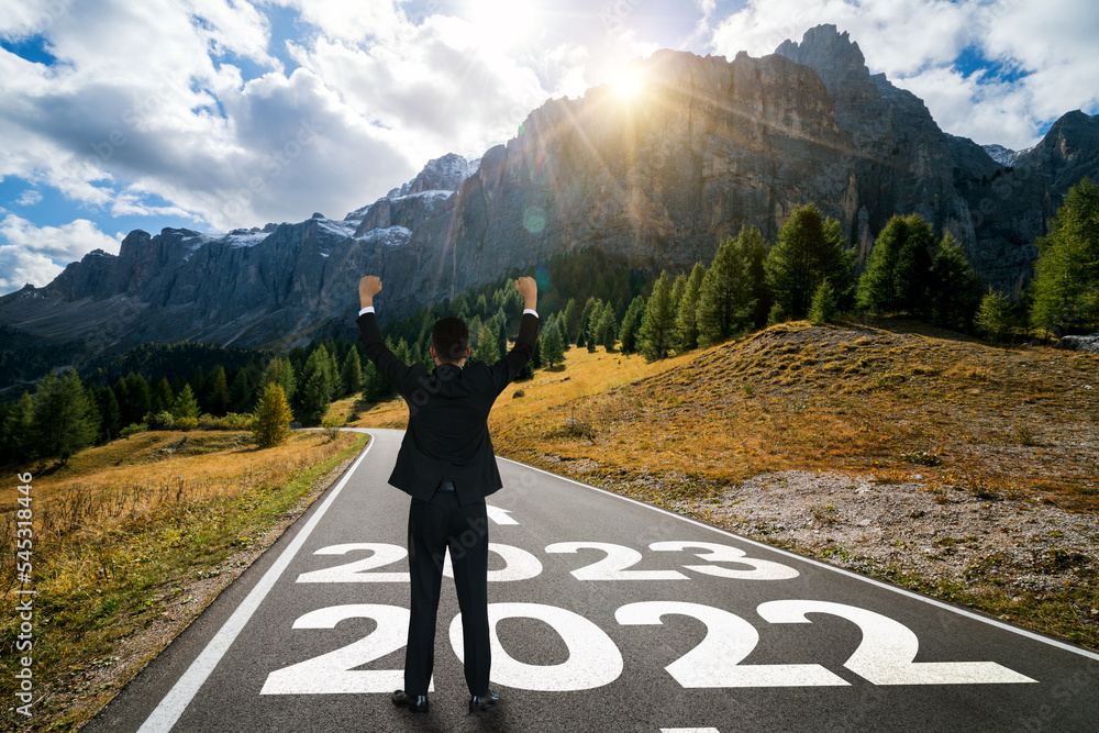 The 2023 New Year journey and future vision concept . Businessman traveling on highway road leading 