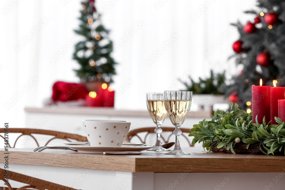 Christmas table setting with glasses of champagne in kitchen, closeup