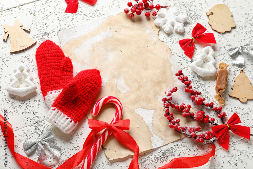 Composition with blank letter to Santa, gloves and Christmas decorations on light wooden background