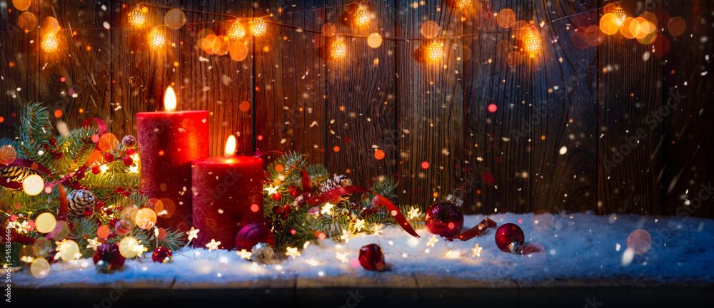 Christmas candles and lights.Red candles with ornament on table