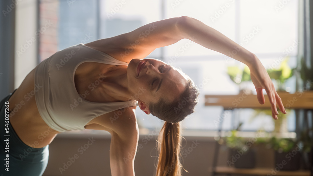 Close Up of a Young Beautiful Female Exercising, Stretching and Practising Yoga in the Morning in He