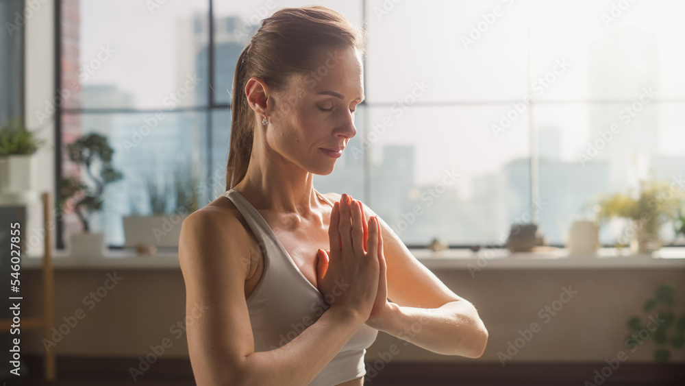 Young Beautiful Female Exercising, Practising Meditation in the Morning in Her Bright Sunny Loft Apa