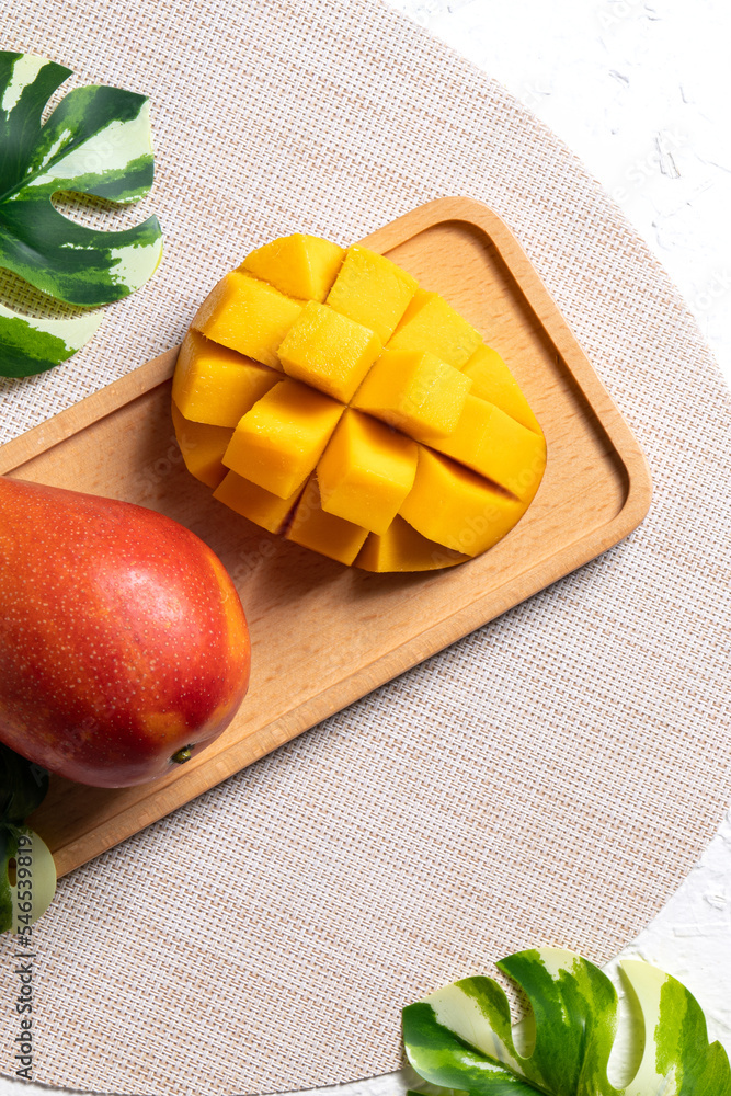 Mango background design concept. Top view Diced fresh mango fruit on white table.