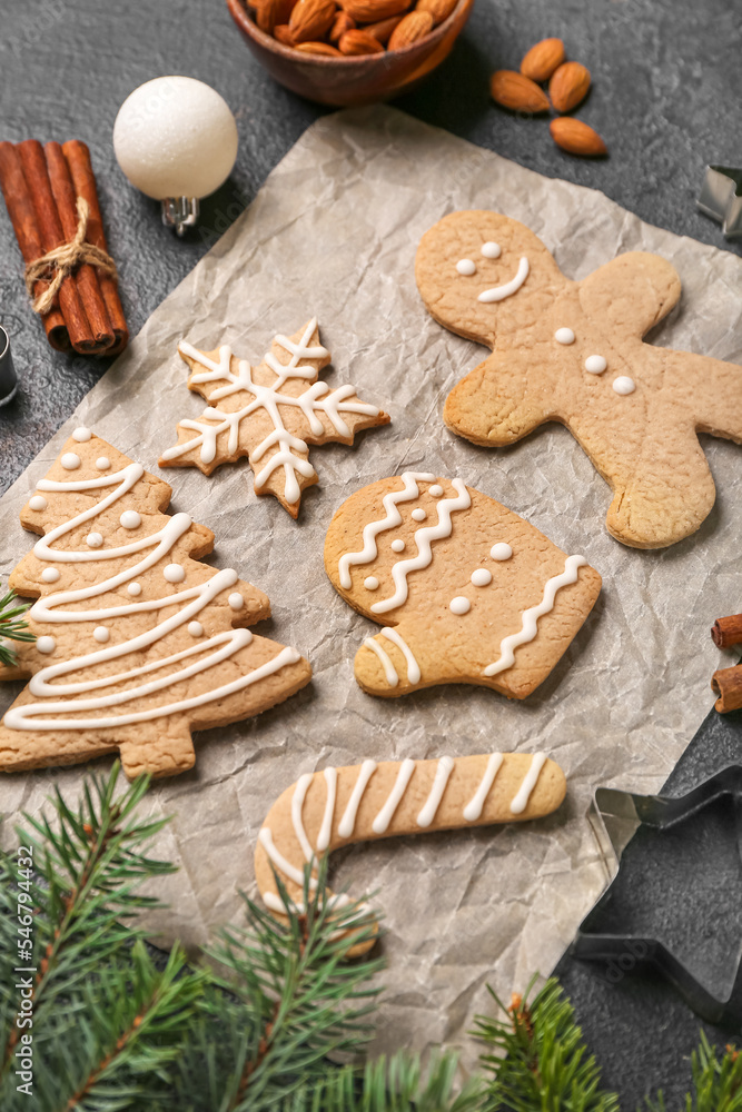 Sheet of baking paper with sweet Christmas cookies on table, closeup