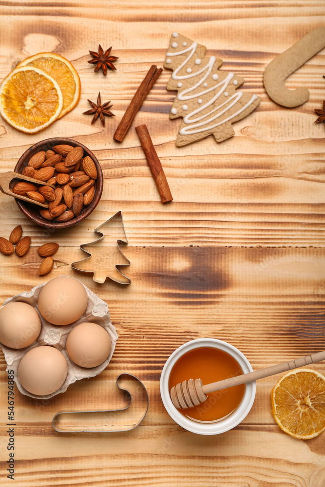 Composition with tasty Christmas cookies, ingredients and cutters on wooden background