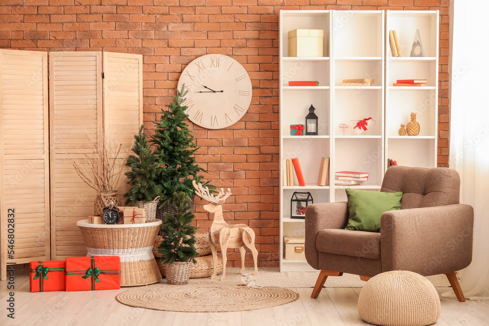 Interior of living room with clocks, Christmas trees and wooden reindeer