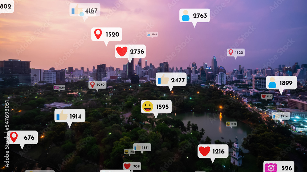 Social media icons fly over city downtown showing people reciprocity connection through social netwo