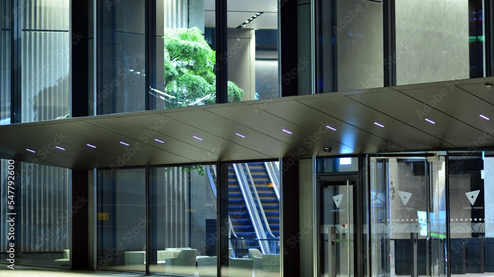 Evening city life in the centre . Large windows of the lobby of an  office building and empty corrid